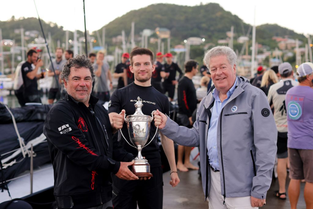 Mitch Booth receives the fine silver IMA Trophy for monohull line honours from Secretary General, Andrew McIrvine © Arthur Daniel/RORC