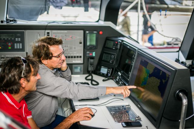  Jean-Paul Riviere and Jacques Delorme on board Finot-Conq 100, Nomad IV, study the weather before the start of the RORC Transatlantic Race. Credit:RORC/James Mitchell
