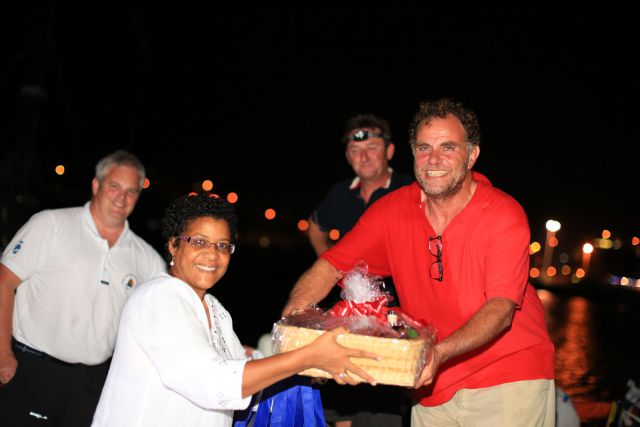 Nikoyan Roberts, Nautical Development Manager at the Grenada Tourism Authority, presented Maurice Benzaquen with a basket of Grenadian goods including Westerhall Rums. (RORC/Arthur Daniel)