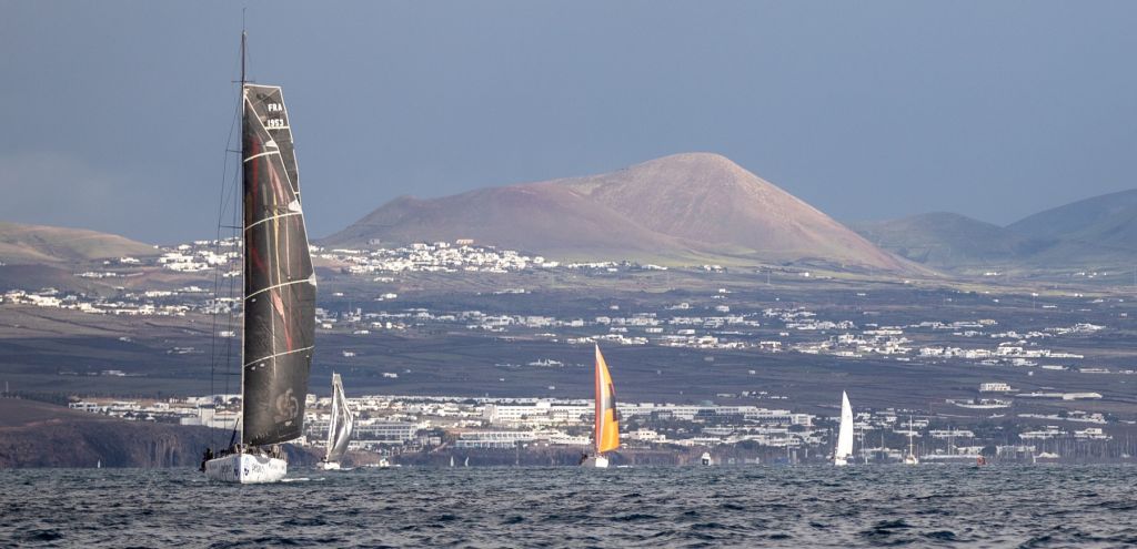 The dramatic volcanic mountains of Lanzarote make an impressive backdrop as the RORC Transatlantic Race fleet head for the Caribbean © James Mitchell