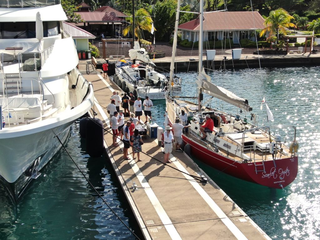 Fellow competitors and the RORC Race and Media Team gather to congratulate Scarlet Oyster. All yachts in the RORC Transatlantic Race receive a great welcome on the dock in Camper & Nicholsons Port Louis Marina, Grenada © Andrew Richards/Pictures of Grenada