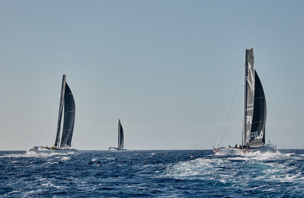 The powerful multihulls head off after the start of the RORC Transatlantic Race © RORC/James Mitchell